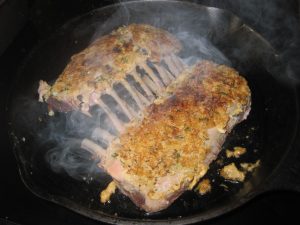 Sear the rack of lamb before baking.